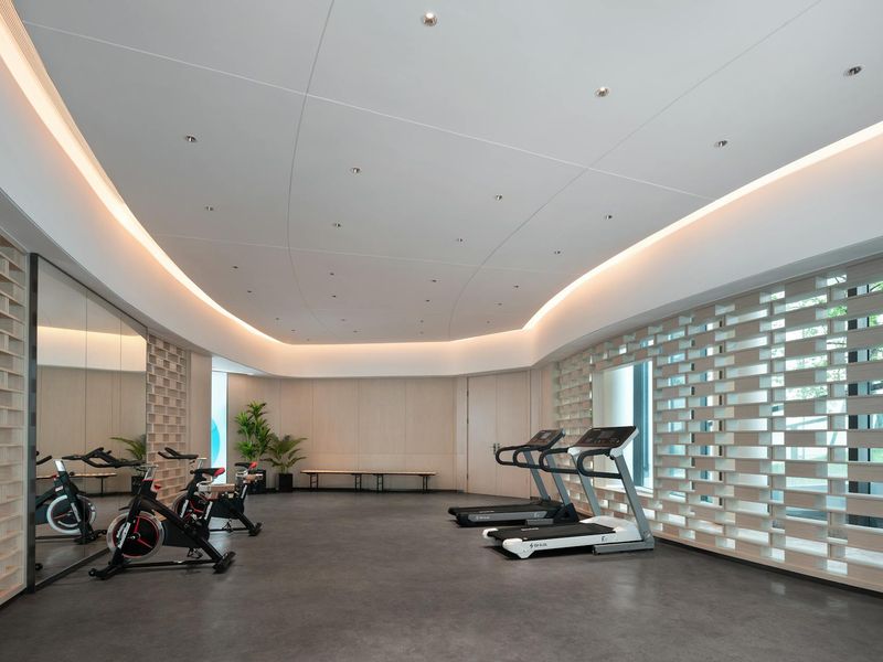 Minimalist fitness equipment on a clean white floor.